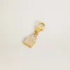 Anhänger in Form eines Schlosses aus goldfarbenem Messing mit Kristallen