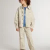 Beigefarbene Kinderjacke mit bunten Farbtupfern