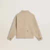Beigefarbene Kinderjacke mit bunten Farbtupfern