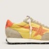 Damen-Marathon mit gelbem Nylon-Obermaterial und orangefarbenem Stern
